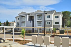 a large apartment building with a parking lot in front of it