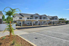 a row of houses with a parking lot in front of them