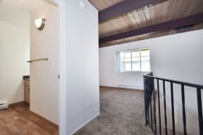 a bedroom with a medium sized bed and a window