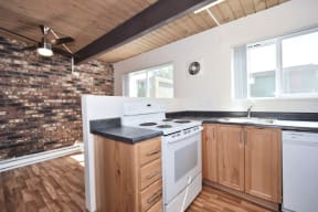 a kitchen with a white stove top oven next to a counter top with a sink