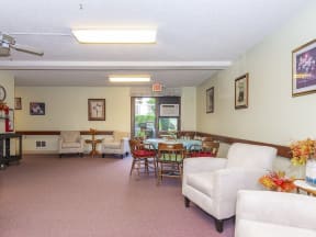 a living room with furniture and a dining room table