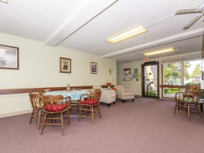 a dining room with a table and chairs