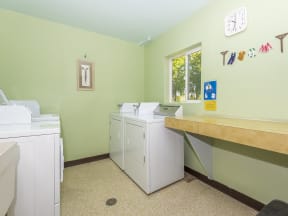 a laundry room with washing machines and a counter