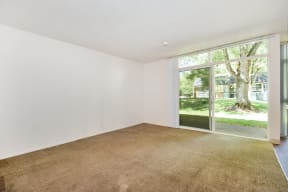 a bedroom with a large window and white walls