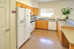 a kitchen with white appliances and wooden cabinets