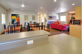 a room with a table and chairs and a couch