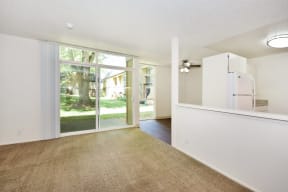 a living room with a white wall and a sliding glass door