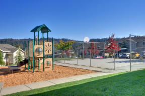 a playground with a basketball hoop in the background