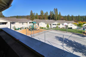 an aerial view of a fenced in backyard with a playground