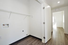 a bedroom with a medium hardwood floor and white walls