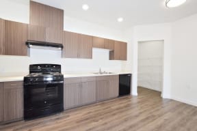 a kitchen with wooden cabinets and a black stove