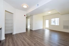 an empty living room with white walls and hardwood floors