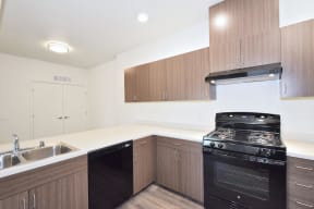 a kitchen with wooden cabinets and black appliances