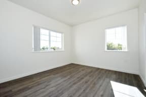 an empty room with two windows