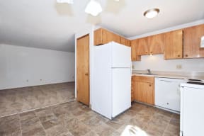 a kitchen with white appliances and wooden cabinets