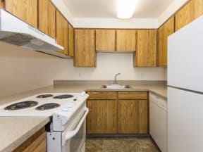 Willow Creek:  a kitchen with white appliances and wooden cabinets