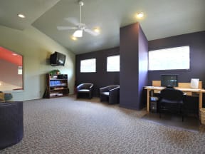 Stone Creek community room a room with a tv and a desk with a computer