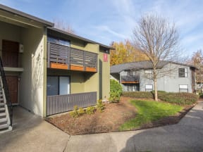 a view of the front of the building with a tree in the front yard