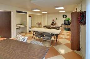 a dining room with a table and chairs and a kitchen