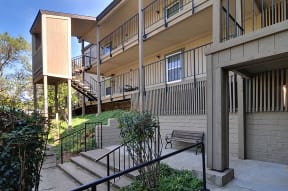our apartments have a spacious courtyard with stairs and a bench