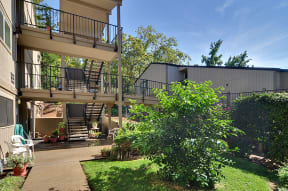 the backyard of a house with a patio and a balcony