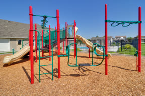 a playground with a slide and monkey bars