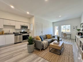 A modern living room with a grey sofa and a wooden coffee table.