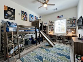 A room with bunk beds and a slide.