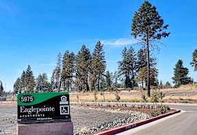 the sign for eagle pointe apartments at the side of the road
