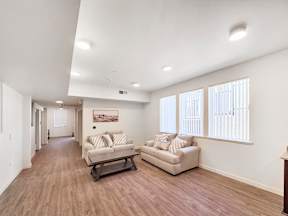 the living room of a home with two couches and a table