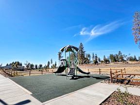 a playground with a swing set in a park