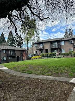 Apartment complex with a green lawn in front.