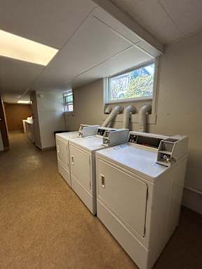 A laundry room with washers and dryers.