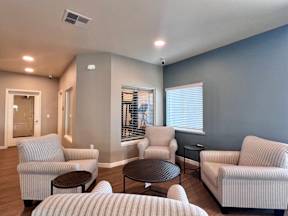 A living room with striped couches and a round table.