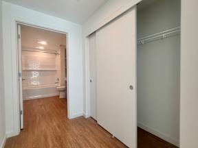 A white bathroom with a toilet and a shower.