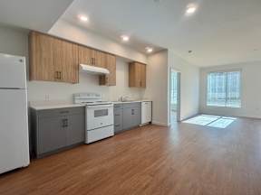 A kitchen with wooden cabinets and a white refrigerator.
