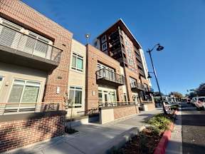 A street view of a residential area with apartment buildings.