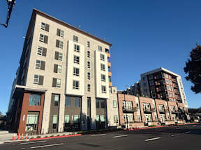 A large building with a red and white striped awning.
