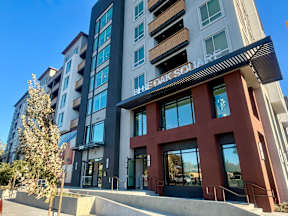 A modern building with a sign that reads "Belle Oak Square".