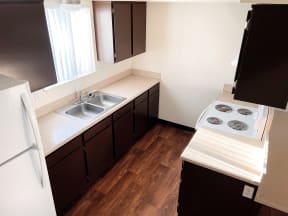 a kitchen with a sink and a stove and a refrigerator