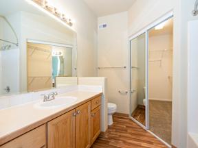 A bathroom with a sink, toilet, and shower.