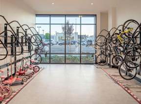 A bike rack with many bikes parked in a hallway.