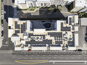 A large building with a lot of windows and solar panels on the roof.
