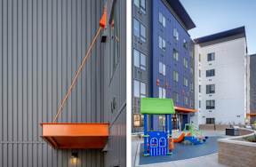 A playground area with a slide and a building with a purple and green awning.