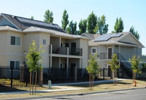 an apartment building with solar panels on the roof