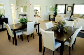 a dining room and living room with a table and chairs