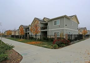 a gray house with a sidewalk in front of it