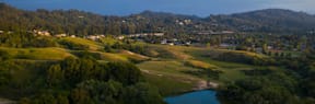 A small town nestled in a valley with a river running through it.