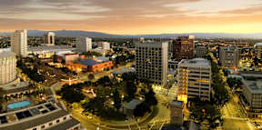 A cityscape at dusk with buildings and a pool.
