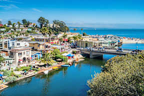 A beautiful coastal town with a bridge over a calm river.